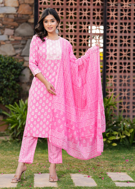 Woman in a pink traditional outfit with a matching dupatta standing outdoors.