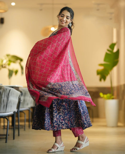 Woman wearing a pink and blue traditional outfit in an indoor setting